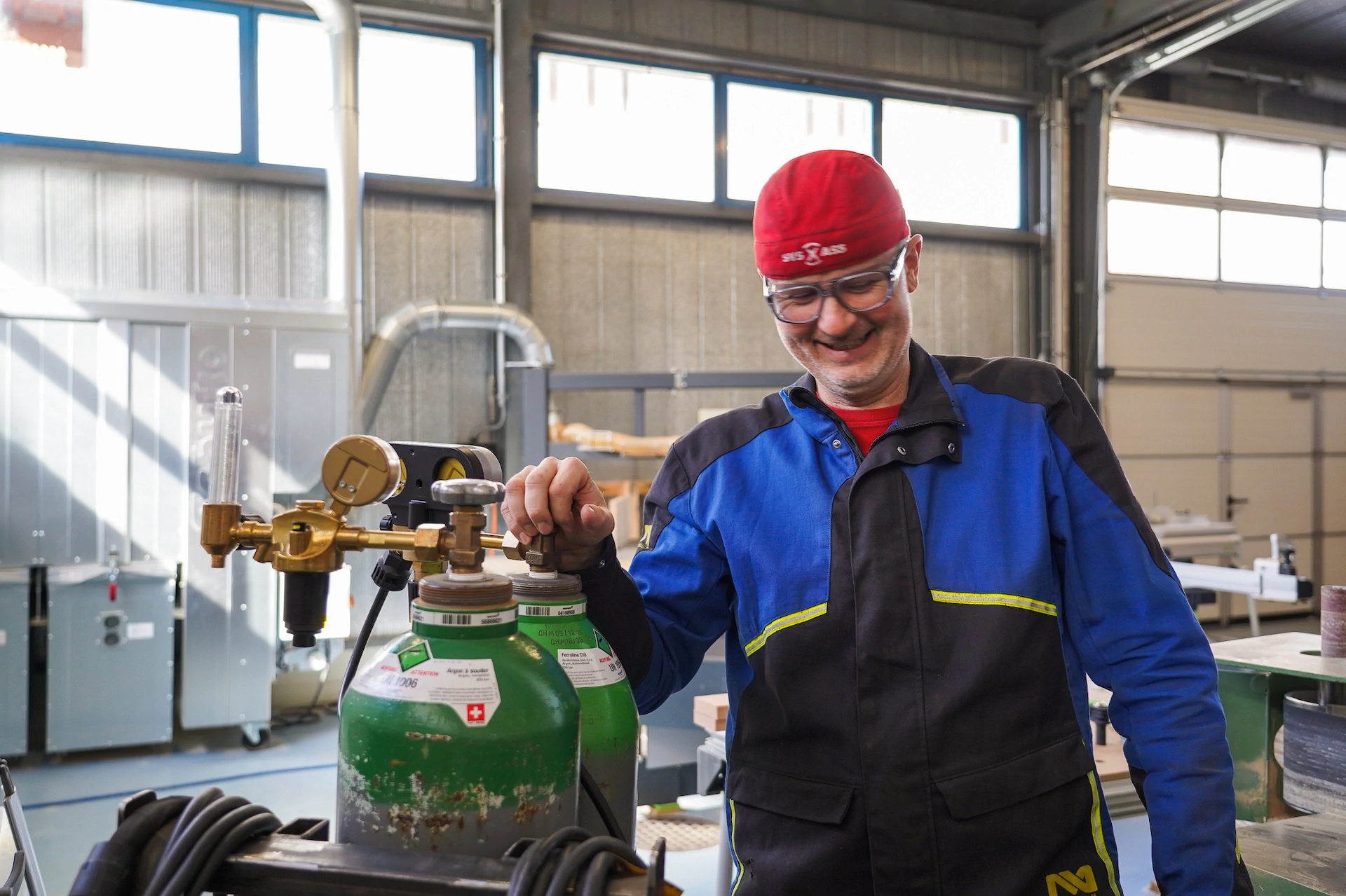 Peter Donatsch in blauer Uniform stützt seine Hand auf eine grüne Gasflasche.